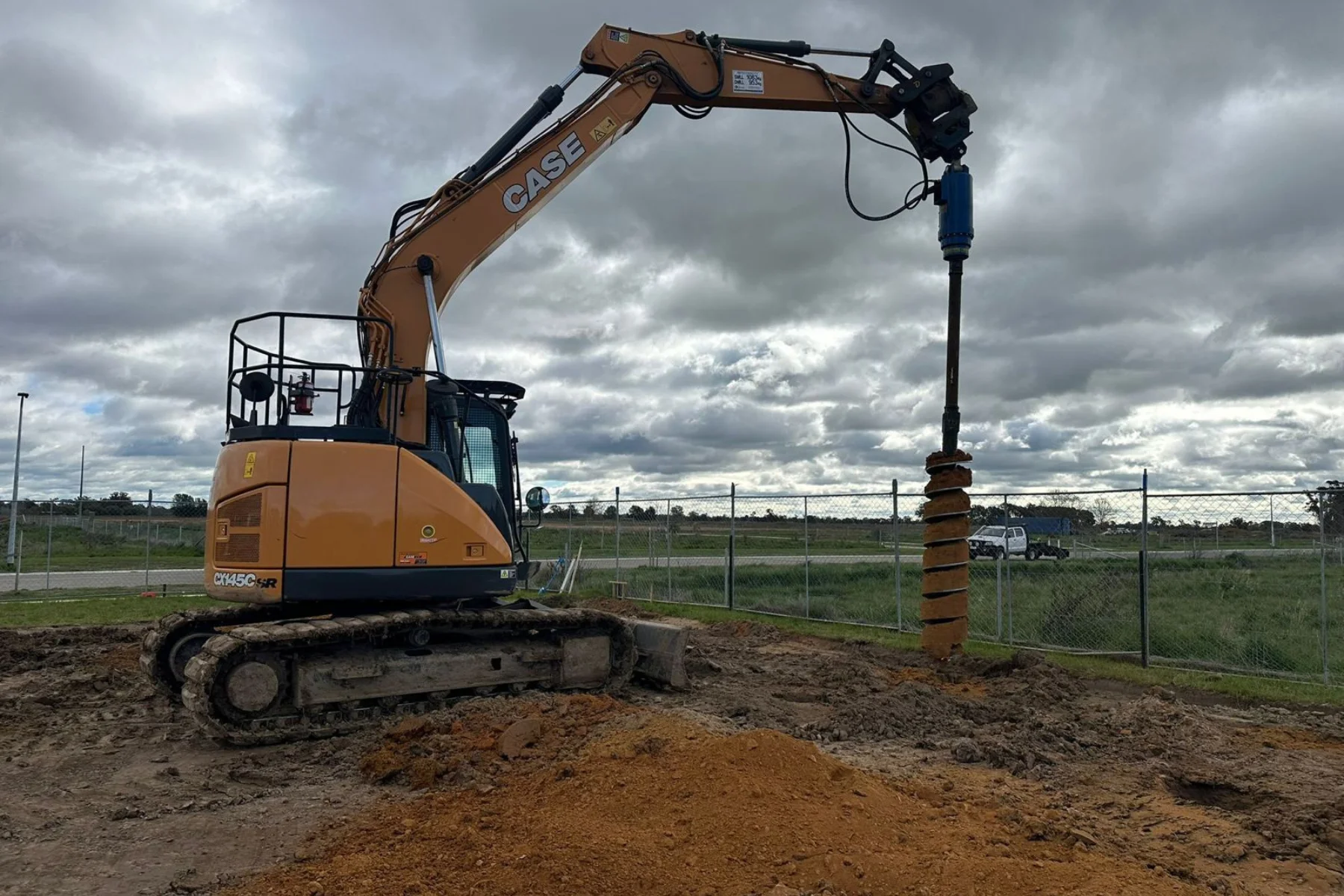 Heavy-duty drill boring into soil